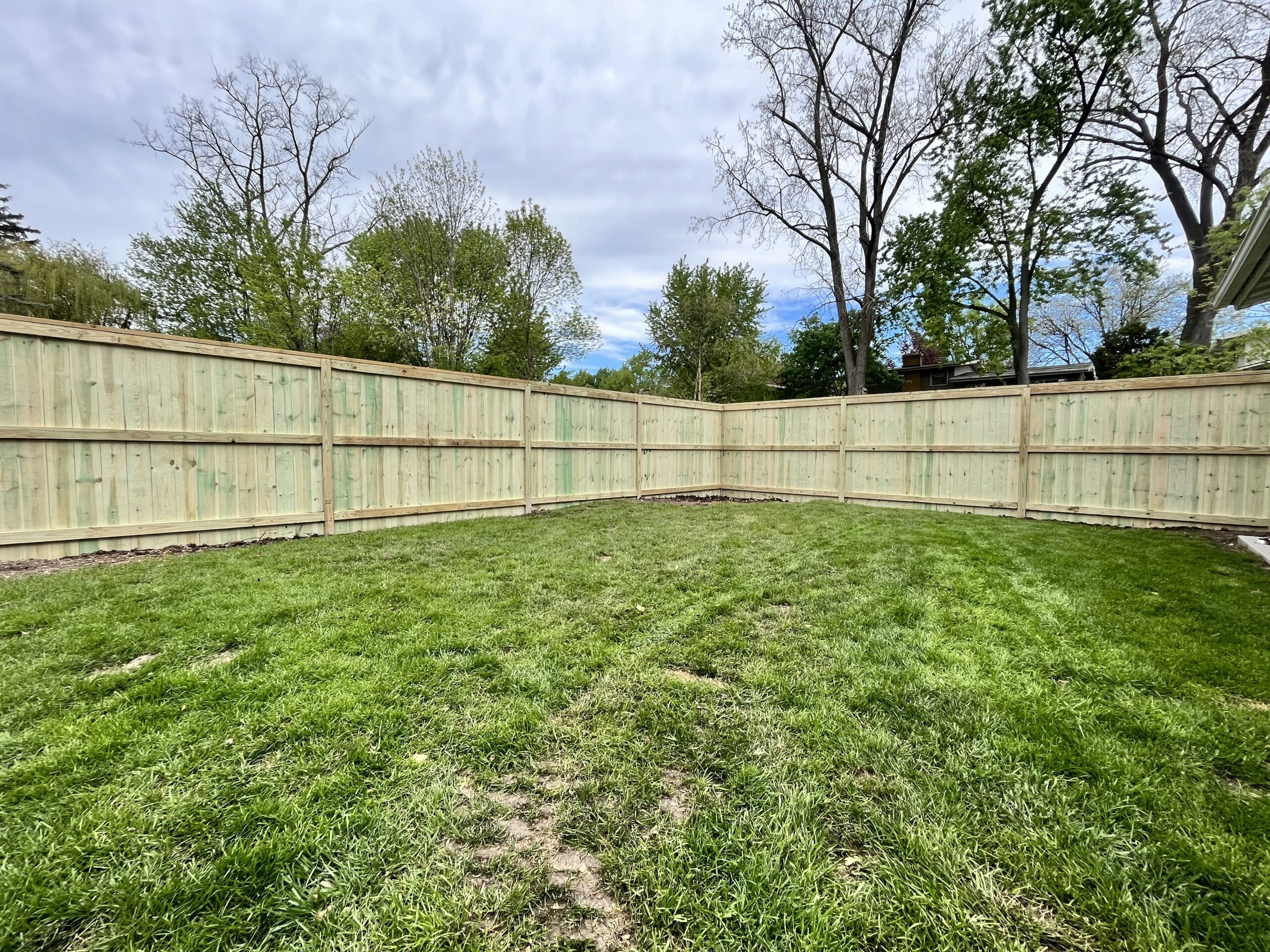 Cedar privacy fence wrapping a Grand Rapids backyard