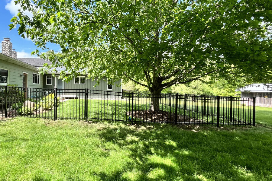 Black aluminum fence gate at a residential property in West Michigan