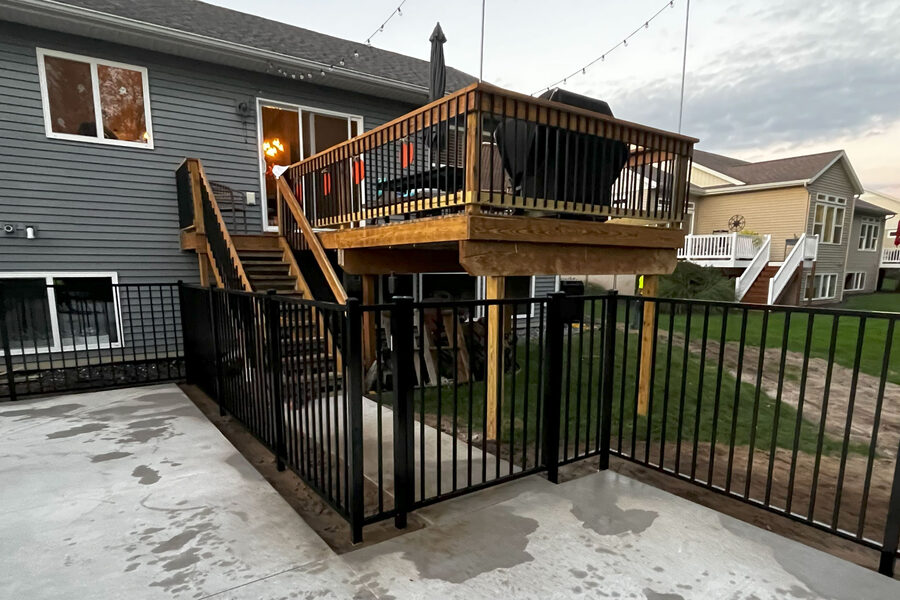 Black aluminum fence installation on a residential West Michigan property