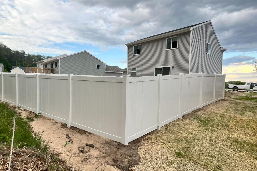 New vinyl privacy fence installation at a West Michigan residential property