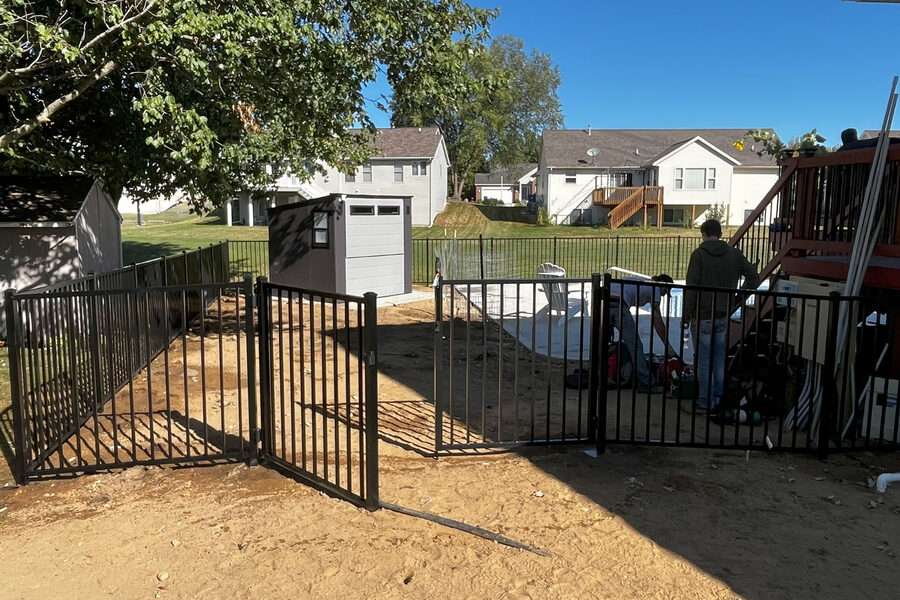 Freshly repaired and restored aluminum fence at a Grand Rapids residential property