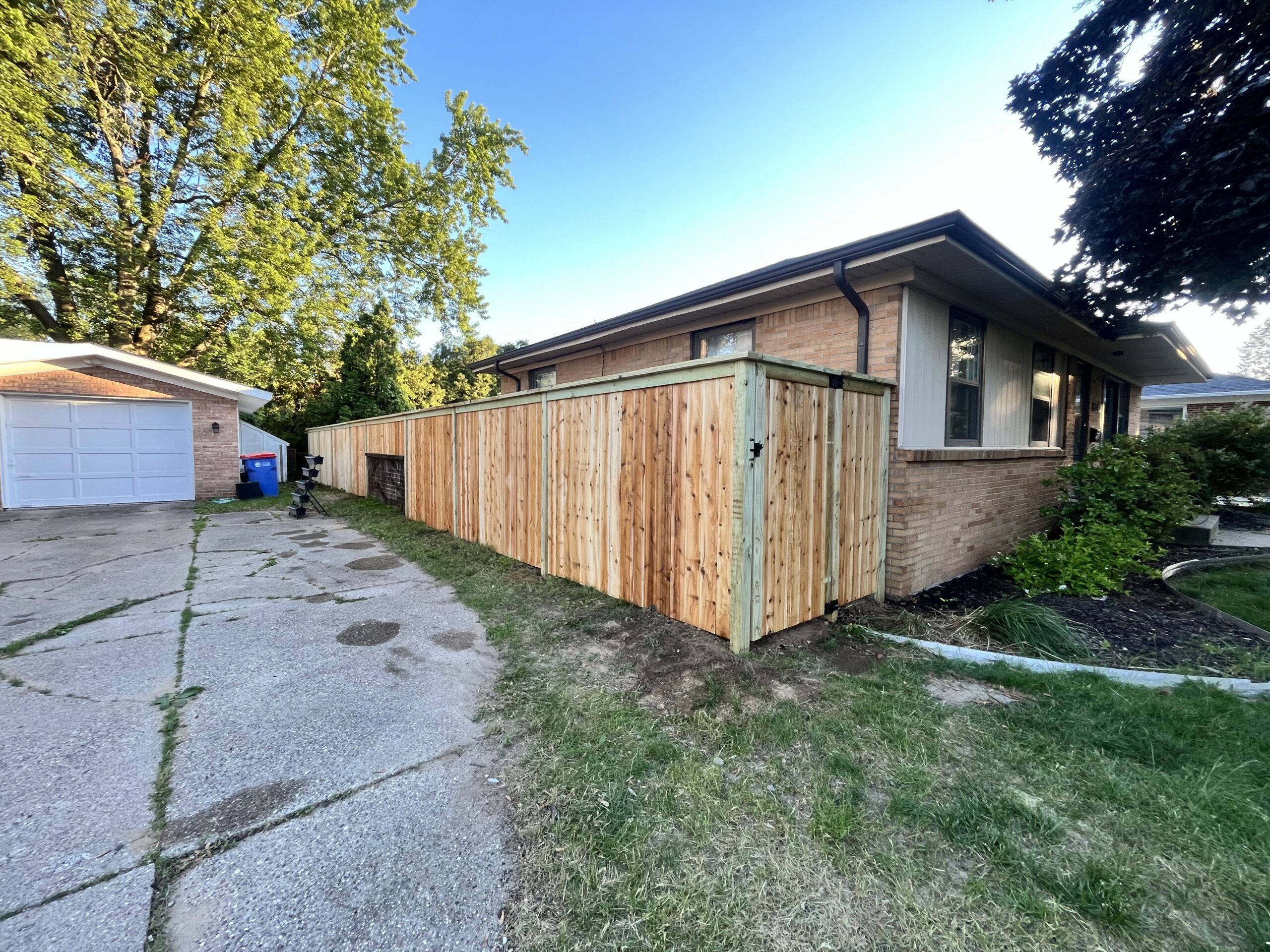 Cedar privacy fence along the side of a Grand Rapids home