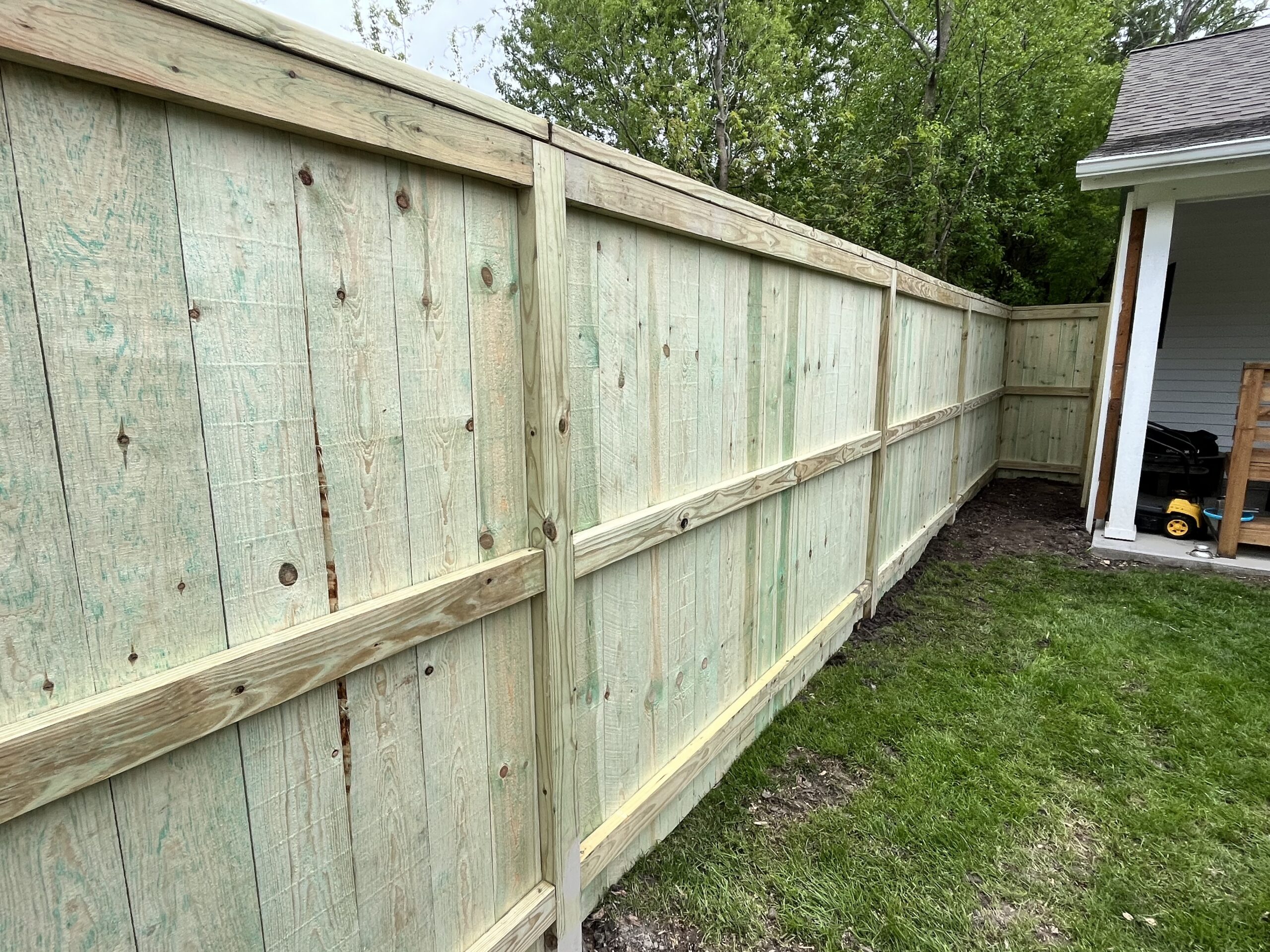 Close-up detail of wood privacy fence board installation